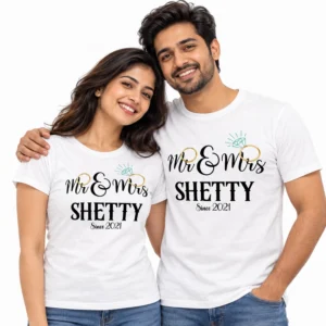 Indian couple wearing matching white Mr. and Mrs. Shetty T-shirts with gold wedding ring graphics, turquoise diamond details, and Since 2021 lettering.