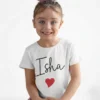 Child wearing personalized white cotton T shirt with custom name print and red heart design