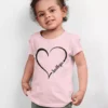 Child wearing pink personalized cotton T shirt with custom name inside heart design