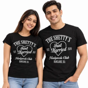 Indian couple wearing matching black The Shetty's Just Married T-shirts with white heart outline, EST. 2026, Newlyweds Club lettering, and Bangalore location text.