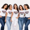 Bride and friends wearing matching white Bride Squad T-shirts with bold patterned lettering
