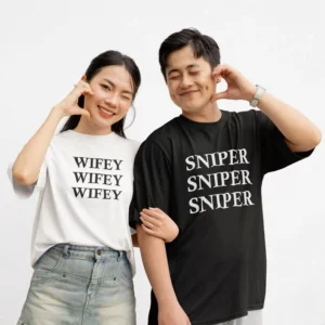 Oversized matching couple t shirts with Wifey and Sniper typography print worn by couple in black and white tees