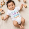 Alt text: Personalised 6 month half birthday baby romper with Ayaansh name and colourful birthday design.