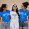 Bride and bridal party wearing personalised pink and white T-shirts with names and roles including bridesmaid and maid of honour