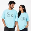 Couple wearing sky blue personalised oversized T-shirts with S and K initials, custom names and established year