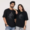 Couple wearing matching black oversized T-shirts with romantic line art illustration and personalised Ayush and Divya names
