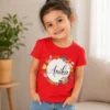 Personalised red girls T-shirt with Anika name inside colourful floral wreath