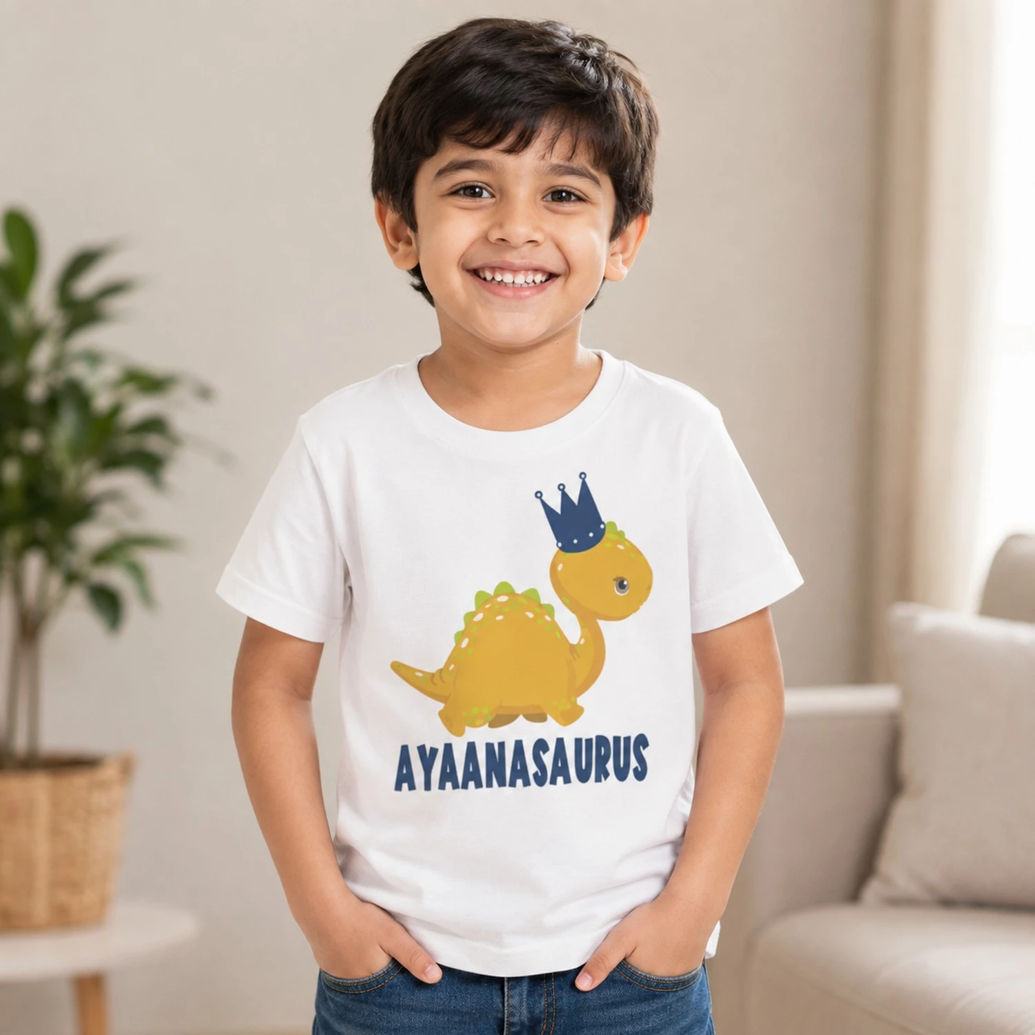 Personalised white boys T-shirt with Ayanasaurus name and crowned dinosaur design