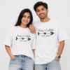 Couple wearing matching white oversized T-shirts with personalised Tanay and Vedhika names, heart arrow and established year