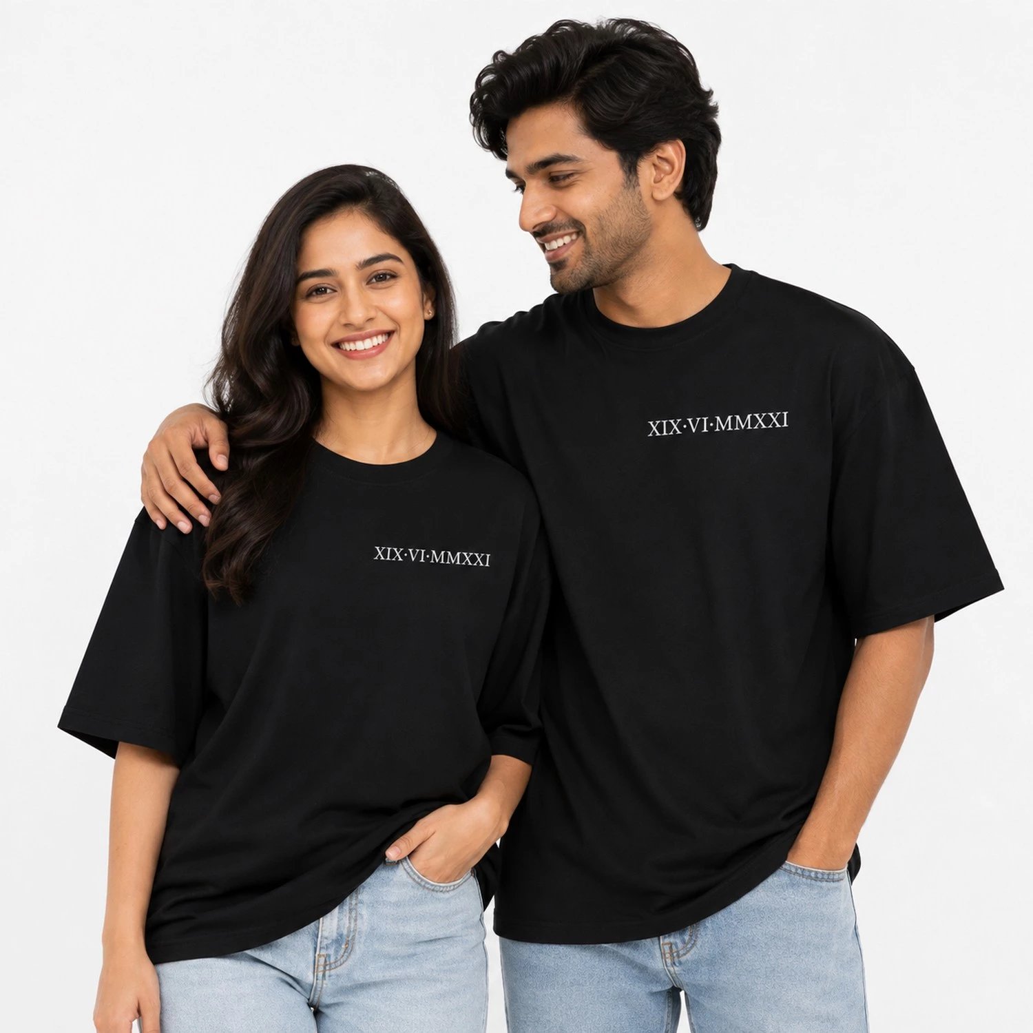 Couple wearing matching black oversized T-shirts personalised with a special date in Roman numerals