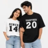 Couple wearing black and white oversized unisex T-shirts with coordinating Since and Together year designs