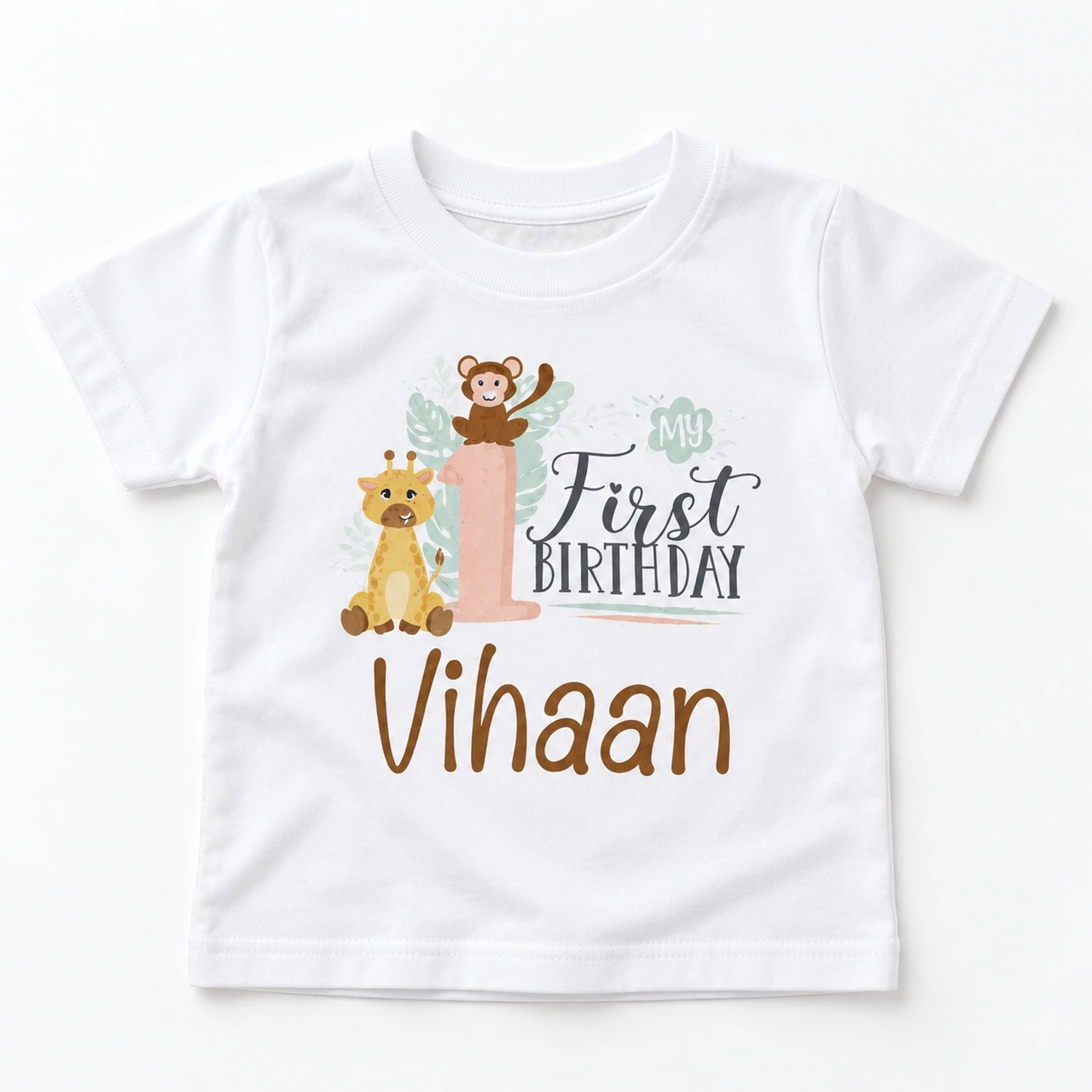 flat lay of a white personalized 1st birthday kids t-shirt with my first birthday jungle print and the name Vihaan