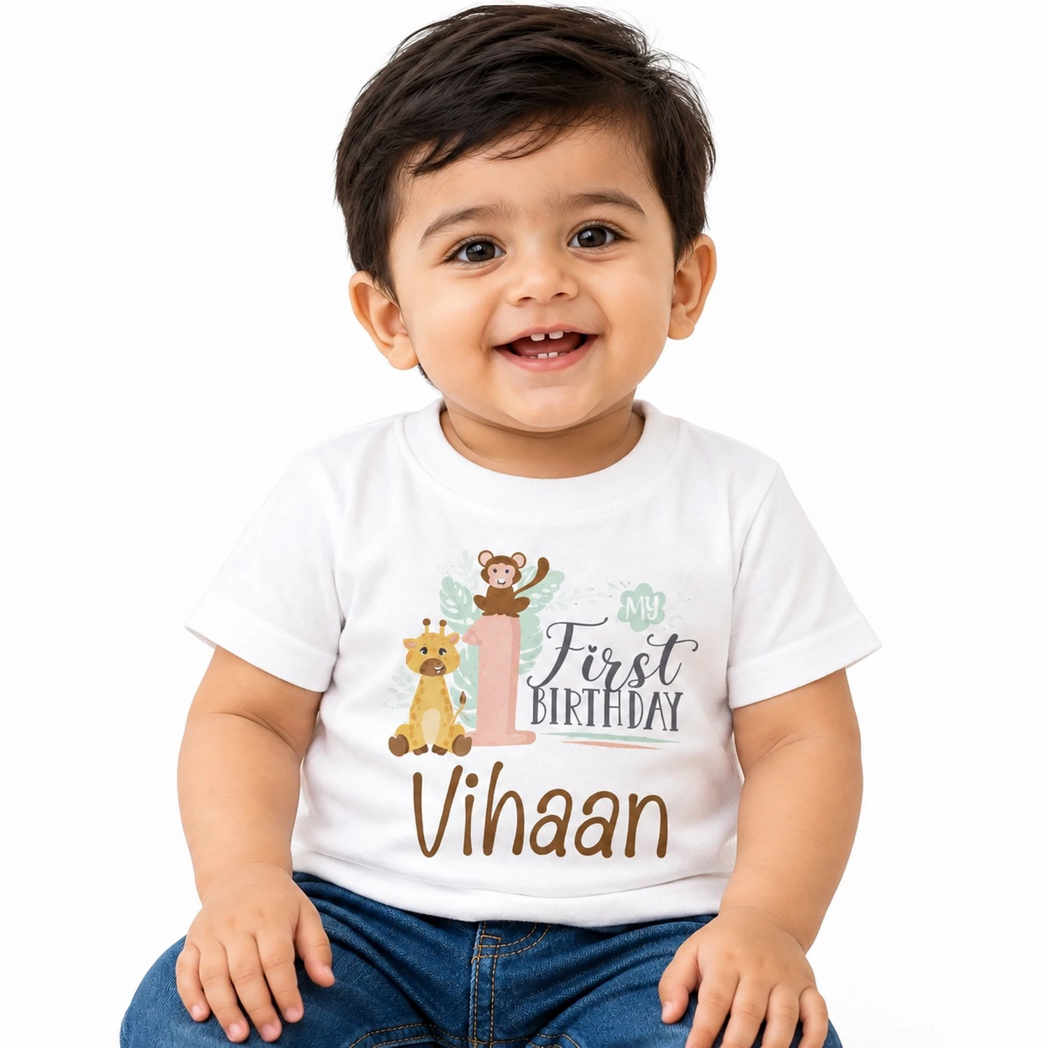 personalized 1st birthday kids t-shirt worn by a smiling toddler, featuring a white tee with my first birthday jungle design and the name Vihaan