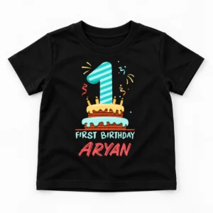 Flat lay of a black personalized 1st birthday kids t-shirt with number 1 cake print, First Birthday text, and the name Aryan.