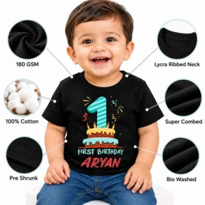 Smiling toddler wearing a black personalized 1st birthday kids t-shirt with visible quality callouts including 180 GSM, 100% cotton, super combed, pre shrunk, bio washed, and lycra ribbed neck.