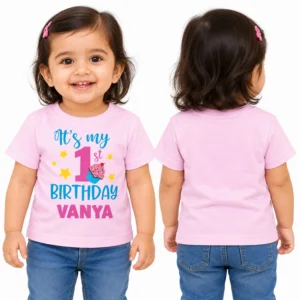 Front and back view of a toddler wearing a pastel pink personalized 1st birthday kids t-shirt with Vanya name print
