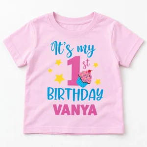 Pastel pink personalized 1st birthday kids t-shirt flat lay with “It’s my 1st Birthday Vanya” design fully visible