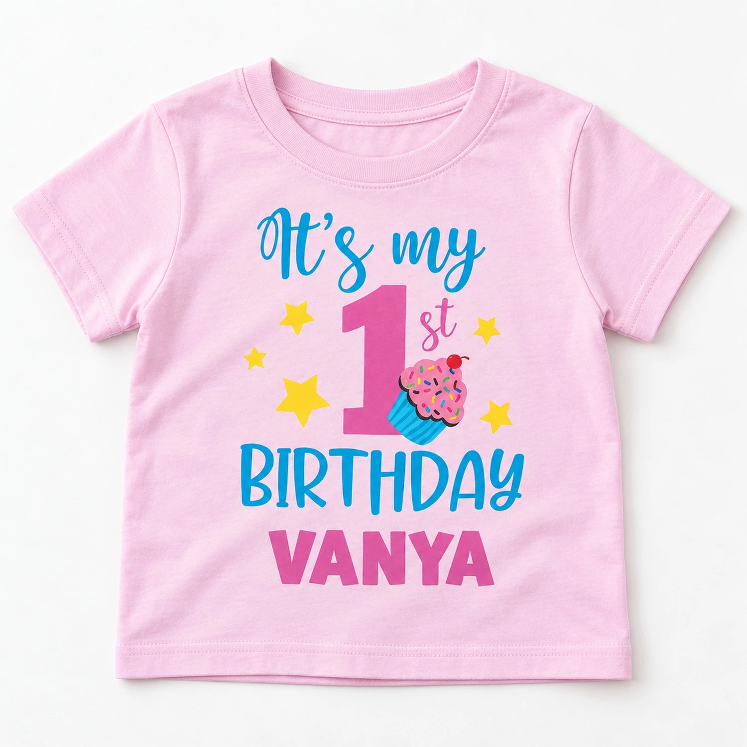 Pastel pink personalized 1st birthday kids t-shirt flat lay with βItβs my 1st Birthday Vanyaβ design fully visible