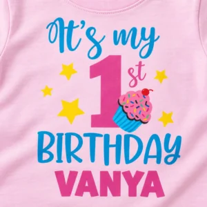 Close-up print detail of a pastel pink personalized 1st birthday kids t-shirt showing βItβs my 1st Birthday Vanyaβ artwork
