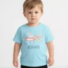 Child wearing light blue personalized cotton T shirt with airplane design and custom name print