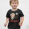 Child wearing black personalized cotton T shirt with astronaut design and custom name print