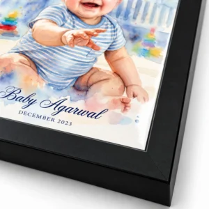 Close-up of the black frame corner and edge of a personalized watercolor baby portrait with custom name and date.