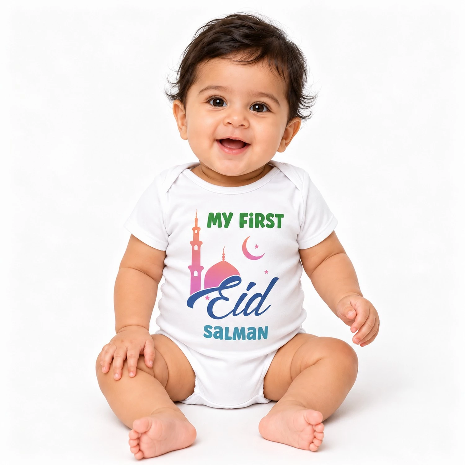 Smiling baby wearing a white personalized First Eid baby romper with the name Salman, mosque, crescent moon, stars, and colorful Eid design.