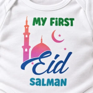 Close-up of a white personalized First Eid baby romper showing the mosque, crescent moon, blue Eid lettering, and custom name Salman.