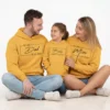 Family wearing personalized mustard cotton hoodies with galaxy theme print for dad mom and baby