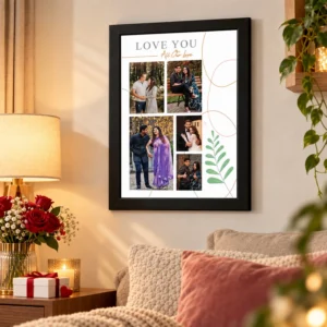 Black personalized couple photo frame displayed on a warm living room wall beside red roses, a lamp and a wrapped gift box.