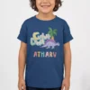 Child wearing navy blue personalized dinosaur birthday T shirt with custom name print in colorful design