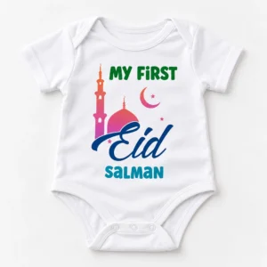White personalized First Eid baby romper laid flat with My First Eid mosque artwork, crescent moon, stars, and the name Salman.