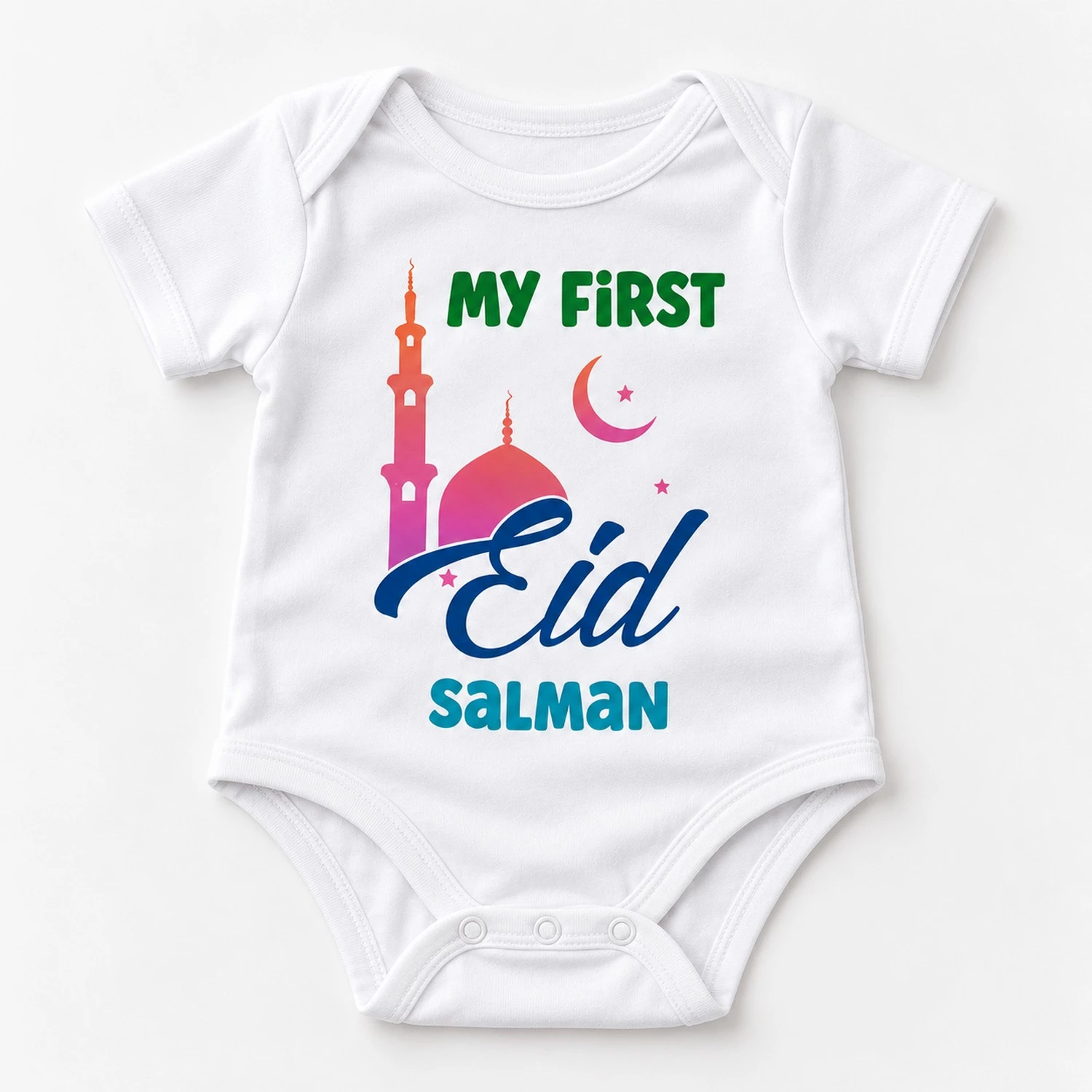 White personalized First Eid baby romper laid flat with My First Eid mosque artwork, crescent moon, stars, and the name Salman.