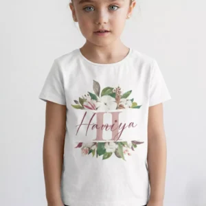 Child wearing personalized floral initial cotton T shirt with custom name print in botanical design