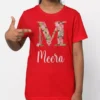 Red cotton personalized T shirt featuring floral letter M and custom name Meera printed on front