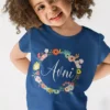 Child wearing navy blue personalized cotton T shirt with floral wreath name print design