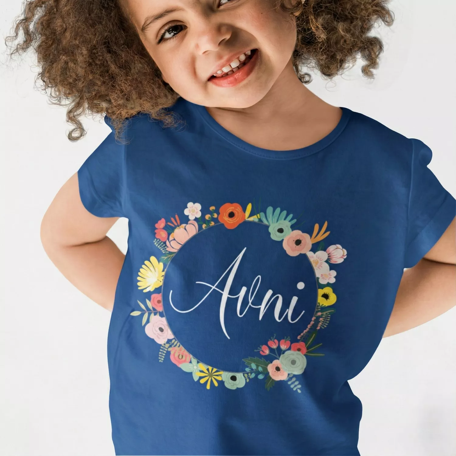 Child wearing navy blue personalized cotton T shirt with floral wreath name print design