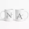 Personalized couple coffee mug set featuring large initial monograms and custom names on white mugs, designed as a husband and wife gift.
