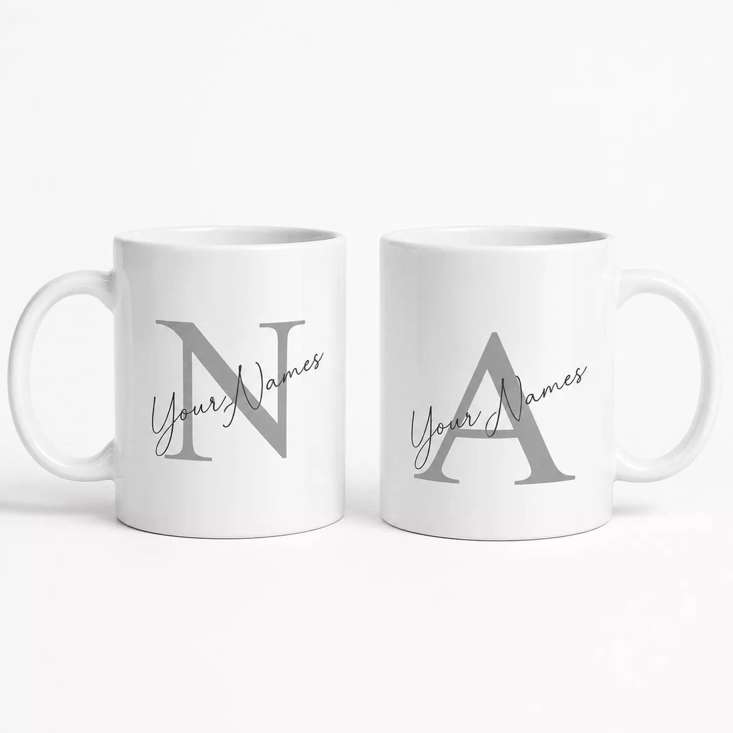 Personalized couple coffee mug set featuring large initial monograms and custom names on white mugs, designed as a husband and wife gift.