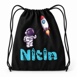 Black personalized kids drawstring bag with the name Nitin, astronaut and rocket design, black drawstrings and turquoise lettering on a white studio background.