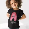 Black cotton kids T shirt with pink monster print and custom name ANVI printed below