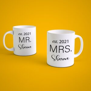 Personalized Mr and Mrs couple coffee mug set with custom surname and wedding year printed on white ceramic mugs for wedding or anniversary gift.
