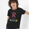 Child wearing black cotton T shirt with personalized initial and name print design