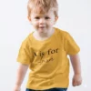 Child wearing yellow personalized cotton T shirt with initial letter and custom name print