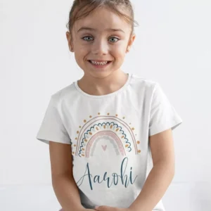 Child wearing white cotton T shirt with pastel rainbow design and custom name print