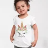 Child wearing white cotton T shirt with floral unicorn design and custom name print