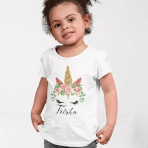 Child wearing white cotton T shirt with floral unicorn design and custom name print