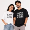 Couple wearing white Wifey and black Sniper oversized unisex matching T-shirts with bold repeated text design