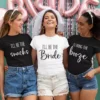 Bride and friends wearing matching bachelorette party t-shirts with fun typography quotes during a bridal celebration