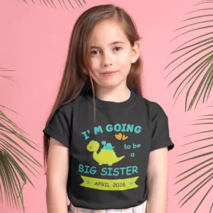 Young girl wearing a black big sister announcement T-shirt with dinosaur design and April 2026 due date text